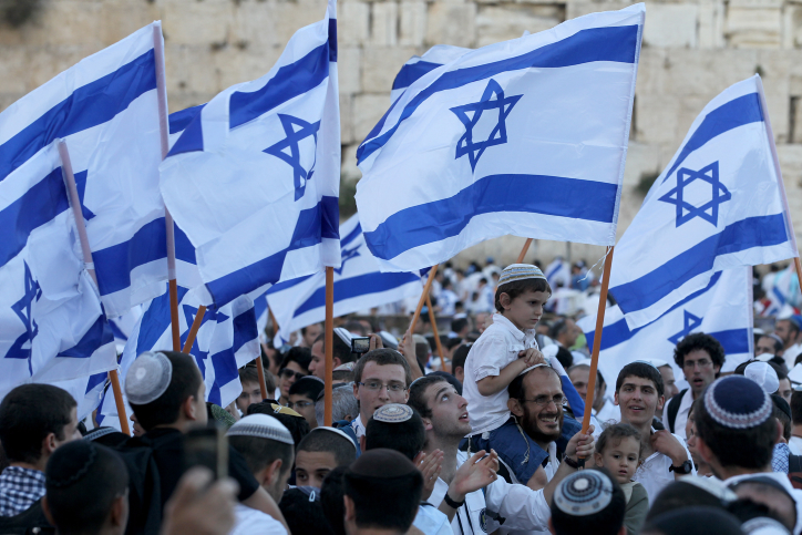 Israelis taking part in the annual flags parade as they celebrating Jerusalem Day in the streets of Jerusalem